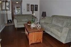 Brampton (Madoc) townhouse for rent - A living room with a couch, a coffee table, and a bicycle on the table.