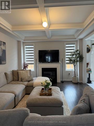North Dumfries apartment for rent - A living room with a grey couch and a fireplace.
