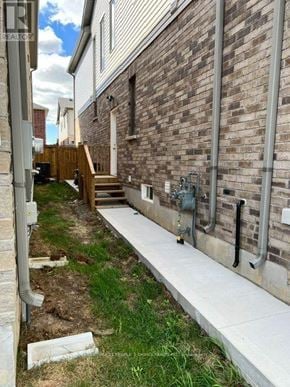 North Dumfries apartment for rent - A brick building with a white wall and a concrete walkway.