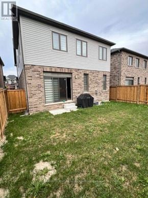 North Dumfries apartment for rent - A house with a grey siding and a brown door.