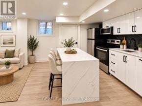 Niagara Falls (Brown) apartment for rent - A modern kitchen with a white island and stainless steel appliances.