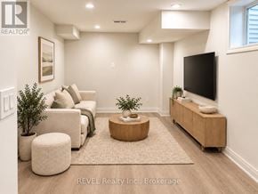 Niagara Falls (Brown) apartment for rent - A living room with a couch, a coffee table, and a flat screen TV.