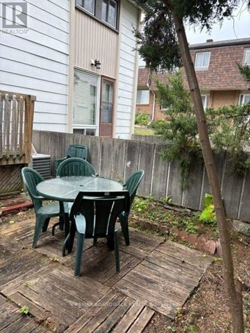 Ottawa townhouse for rent - A wooden deck with a green table and chairs.
