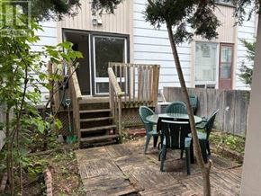 Ottawa townhouse for rent - A backyard with a table and chairs.