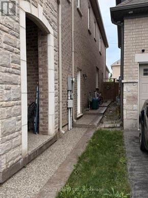 Milton (Cb Cobban) apartment for rent - A narrow alley between two buildings with a car parked on the right side.