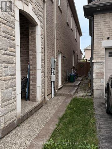 Milton (Cb Cobban) apartment for rent - A narrow alley between two buildings with a car parked on the right side.