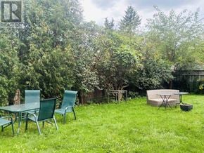 Toronto (Victoria Village) apartment for rent - A backyard with a table and chairs and a trampoline.
