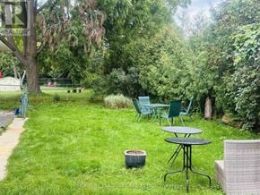 Toronto (Victoria Village) apartment for rent - A backyard with a table and chairs.