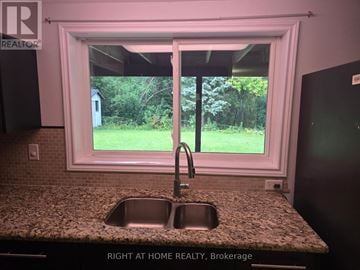 Richmond Hill (North Richvale) apartment for rent - A kitchen with a granite countertop and a sink under a window.