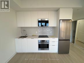 Brampton (Bram East) condo for rent - A modern kitchen with white cabinets and stainless steel appliances.