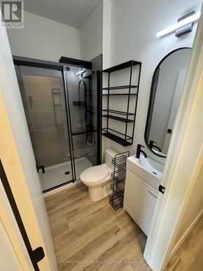 Ottawa multi-family for rent - A bathroom with a walk in shower and a toilet.