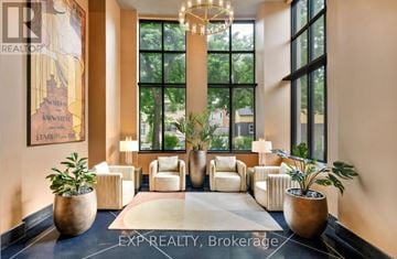 Ottawa condo for rent - A well-lit, modern living room with a large window and a chandelier.
