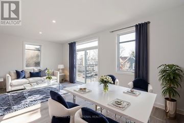 Ottawa triplex for rent - A modern living room with a white dining table and blue chairs.