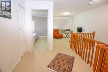 Ottawa townhouse for rent - A living room with a couch and a rug on the floor.