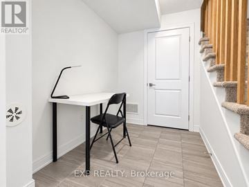 Barrie (Innis-Shore) townhouse for rent - A room with a desk and chair in it.