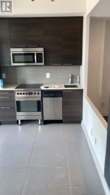 Toronto (Waterfront Communities) condo for rent - A modern kitchen with a stainless steel oven and microwave.