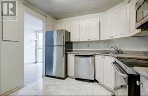 Toronto (Mount Olive-Silverstone-Jamestown) condo for rent - A kitchen with white cabinets and a stainless steel refrigerator.