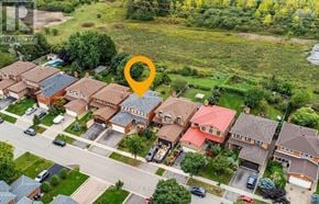 Mississauga (Central Erin Mills) apartment for rent - A bird's eye view of a residential area with houses and streets.