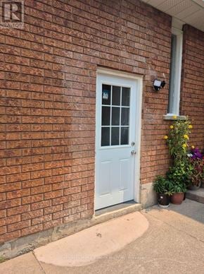 Mississauga (Central Erin Mills) apartment for rent - A white door is on the left side of a brick wall.