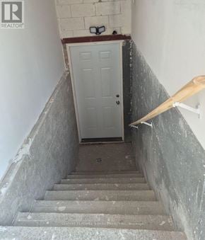 Mississauga (Central Erin Mills) apartment for rent - A staircase with a white door at the bottom.