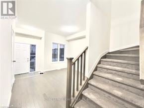 Loyalist (Bath) apartment for rent - A staircase with a wooden banister leads up to a second floor.