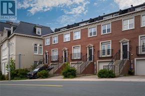 St. John's apartment for rent - A row of red brick townhouses with a black car parked in front of the first one.