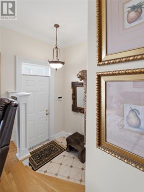 St. John's apartment for rent - A hallway with a rug and a picture of a pear on the wall.