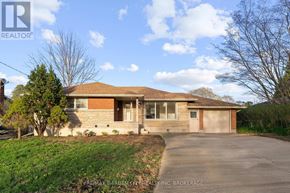 St. Catharines (Carlton/Bunting) apartment for rent - A house with a brown roof and a driveway in front.