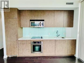 Toronto (Waterfront Communities) condo for rent - A kitchen with wooden cabinets and a green oven.