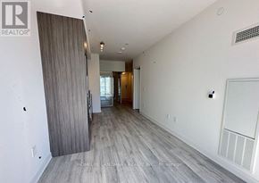 Toronto (Waterfront Communities) condo for rent - A spacious room with a sliding door leading to a balcony.