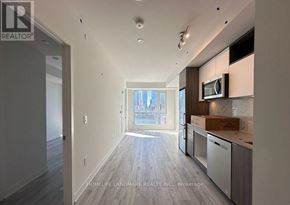 Toronto (Waterfront Communities) condo for rent - A spacious kitchen with a microwave and a box on the counter.