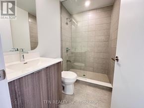 Toronto (Waterfront Communities) condo for rent - A bathroom with a toilet, sink, and shower.
