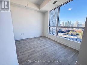 Toronto (Waterfront Communities) condo for rent - A room with a large window overlooking a cityscape.