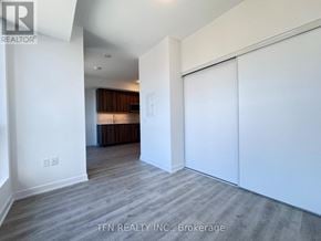 Toronto (Waterfront Communities) condo for rent - A room with a white wall and a wooden floor.