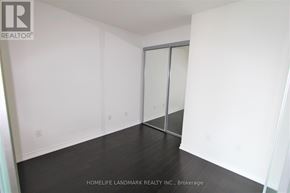 Toronto (Bay Street Corridor) condo for rent - A room with a sliding door and a wooden floor.