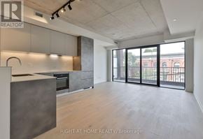 Toronto (South Riverdale) condo for rent - A spacious kitchen with a large island and a view of the city.