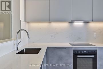 Toronto (South Riverdale) condo for rent - A modern kitchen with a sink and stove top oven.