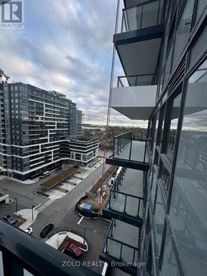 Pickering (Bay Ridges) house for rent - A modern glass building with a parking lot in front.
