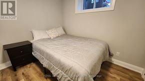 Mississauga (Lakeview) apartment for rent - A bedroom with a bed, nightstand, and window.