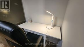 Mississauga (Lakeview) apartment for rent - A white desk with a lamp and a chair in front of a sign that says REALTOR.