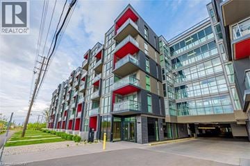 Burlington condo for rent - A modern multi-story building with a glass facade and red accents.