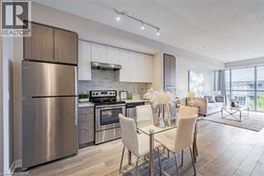 Burlington condo for rent - A modern kitchen with a dining area and a view of the city.
