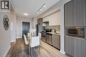 Burlington condo for rent - A modern kitchen with a dining table and chairs.