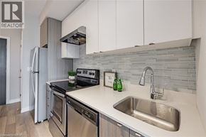 Burlington condo for rent - A modern kitchen with a stainless steel refrigerator and a sink.