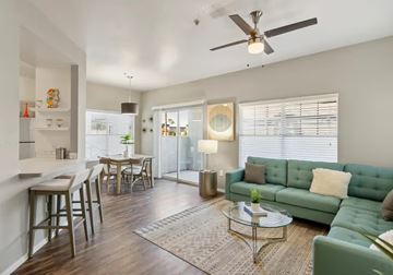 Chandler apartment for rent - A living room with a green couch and a glass table.