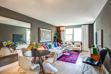 Redwood City apartment for rent - A living room with a purple rug and a white couch.