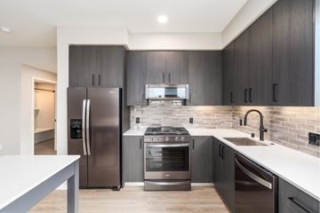 Santa Clara apartment for rent - A modern kitchen with dark wood cabinets and stainless steel appliances.