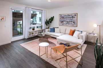 Redmond apartment for rent - A living room with a white couch and a brown chair.