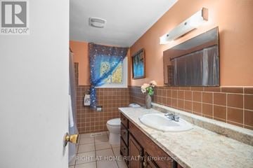 London North (North Q) apartment for rent - A bathroom with a toilet, sink, and mirror.