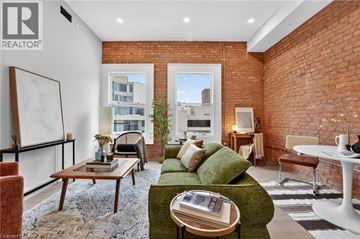 Hamilton apartment for rent - A living room with a green couch and a white table.